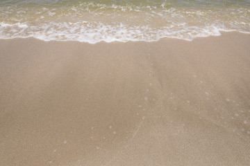 Fototapeta na wymiar Sand beach and soft wave
