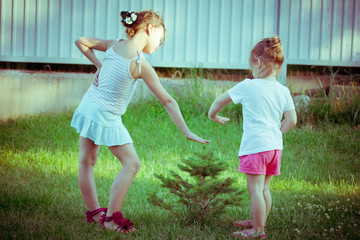 Fototapeta premium two little girls in garden