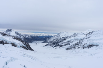 snow scene on alpes mountains in cloud sky