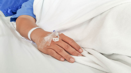 close up of saline solution preparation on hand of man patient