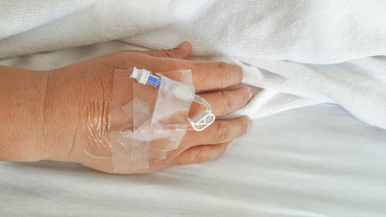 close up of saline solution preparation on hand of man patient