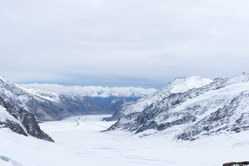 snow scene on alpes mountains in cloud sky
