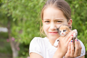 
girl holding a kitten