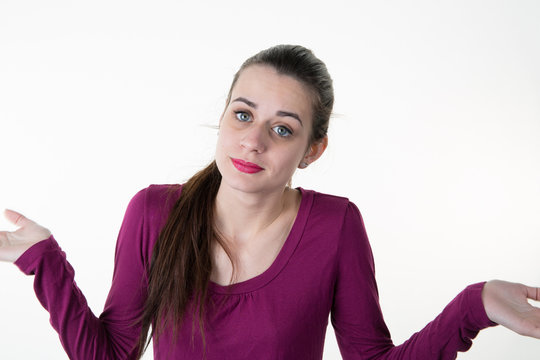 Woman Shrugs Her Shoulders With Her Eyebrows Raised. Isolated