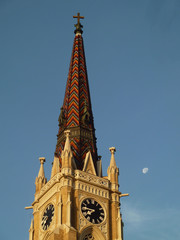 Tower of church with clock and moon