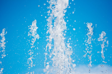 Naklejka na ściany i meble Water fountain water jet over blue sky