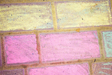 chalk drawing of rainbow and color chalks on asphalt