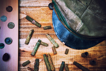 Old cartridge shells, various coins and military cap