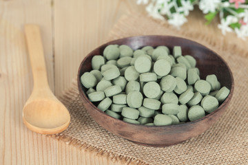 Fototapeta na wymiar Herbal pill on wooden bowl. herb for healthy living.