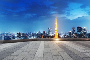 empty street with cityscape and skyline of tokyo at twilight
