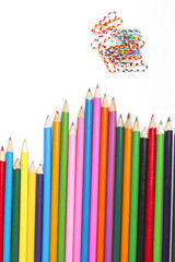 Fototapeta premium Color pencils and color paper clip isolated on white backgroun