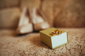 Pretty good wedding bouquet of various flowers with bride shoes. Close-up