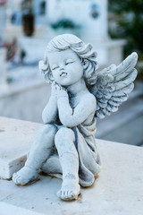 A small sculpture of an angel in the cemetery. 