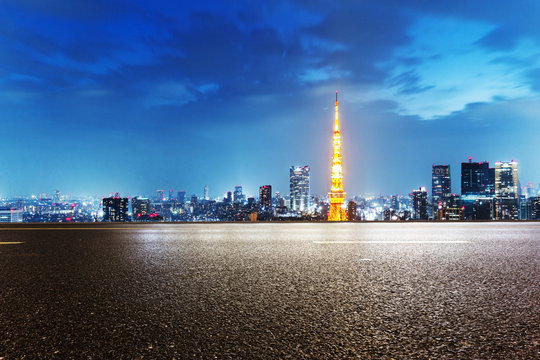 empty street with cityscape and skyline of tokyo at twilight