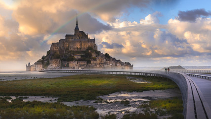 Rainbow over Mont Saint Michel after raining with walkway