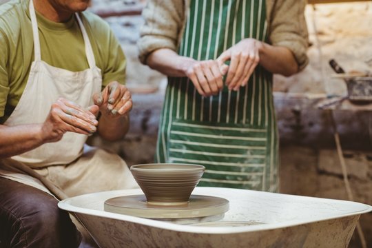 Midsection of potters working 