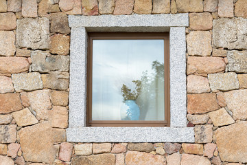 Window of Stone / Open window on a block of granite wall with a vase of ears of corn.