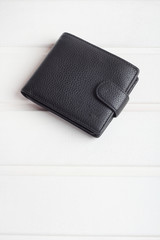 men's black wallet money in cash wooden white vintage background
