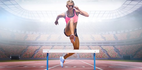 Composite image of athletic woman practicing show jumping - obrazy, fototapety, plakaty