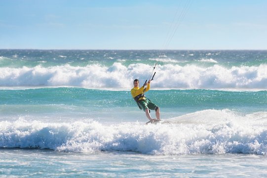 Man kitesurfing in heavy sea