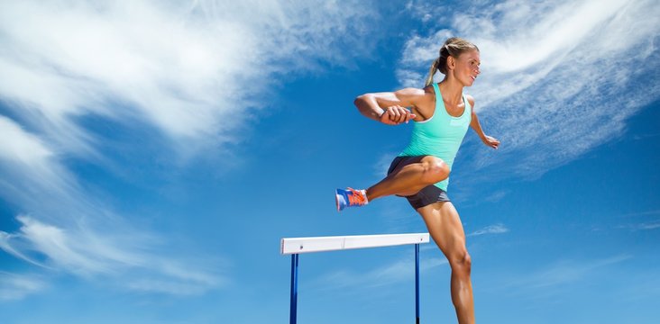 Composite image of sportswoman practising the hurdles