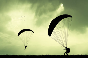 paragliding at sunset - obrazy, fototapety, plakaty