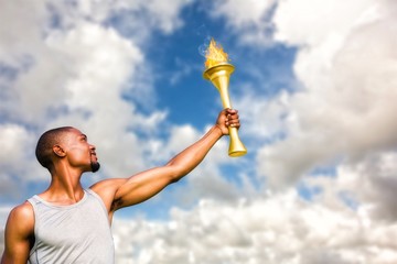 Composite image of front view of sportsman holding a cup 