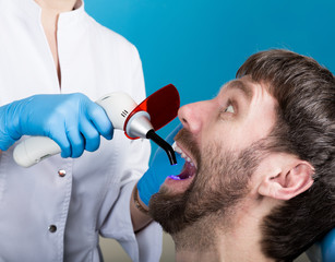 Doctor examines the oral cavity on tooth decay. Caries protection. Tooth decay treatment. Dentist...