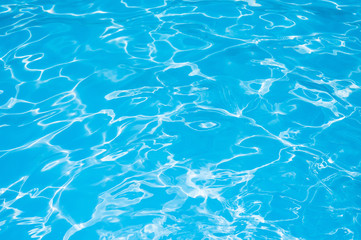 Water in swimming pool, Blue Water surface with sun reflection, Beautiful Blue and Bright ripple water surface