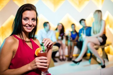 Portrait of young woman having a cocktail