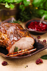 Roast pork with cranberry dip, basil, coriander and rosemary. © gkrphoto