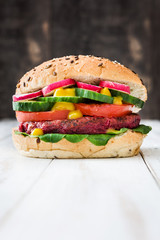 Veggie beet burgers on white wooden background
