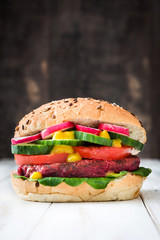 Veggie beet burgers on white wooden background

