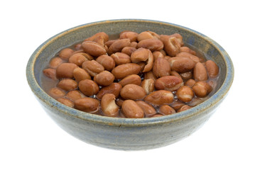 Bowl of shelled beans on a white background.