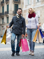 pensioners with shopping bags  on city street