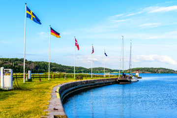 The beginning or end of the Swedish Gota canal at Mem with sailing boats moored at the pier and the archipelago in background. Fine summer weather.