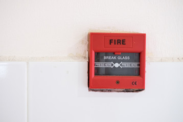 Push button switch fire or fire alarm button emergency on concrete wall.