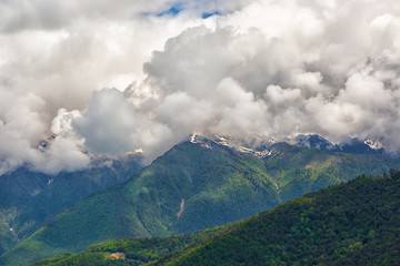 Large cumulus clouds over the mountains of the Caucasus Mountains