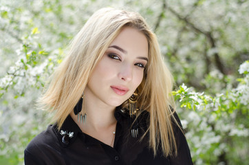 Beautiful girl in the flowered background