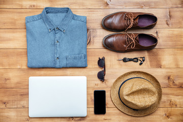 Travel concept shoes, shirt, mobile phone, earphones, laptop, ha