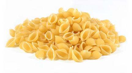 Heap of uncooked italian pasta shells on a white