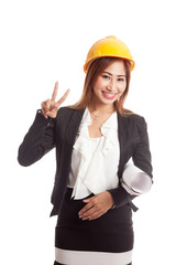 Asian engineer woman with blueprints show victory sign