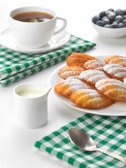 Madeleine biscuits with hot drink, studio shot