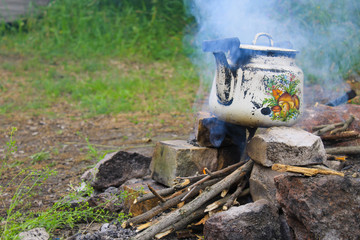 Kettle over burning campfire