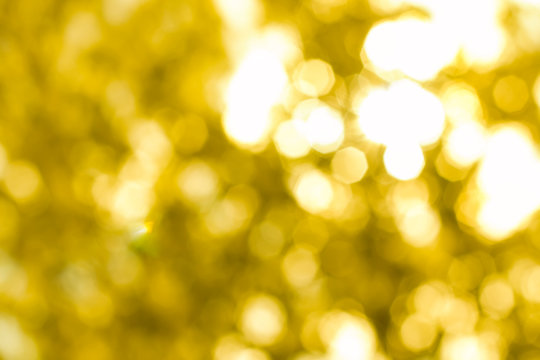 Beautiful sparkling abstract golden bokeh background defocused