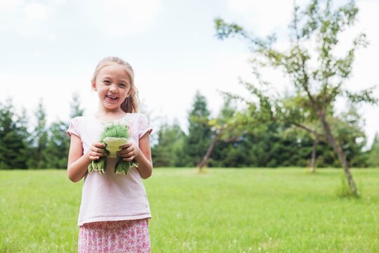 Girl outdoors with soft toy