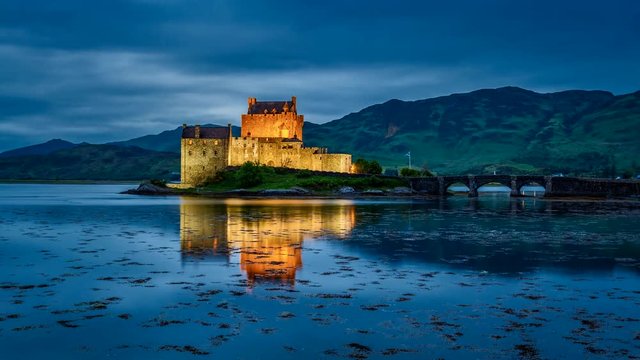 Beautiful sunset over the lake at Eilean Donan Castle in Scotland, 4k, timelapse