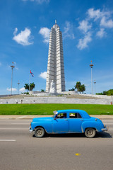Old american car in front of the Revolution Square in Havana