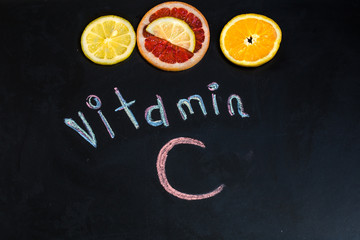 word vitamin C, citrus fruits, the  is written on black chalkboard