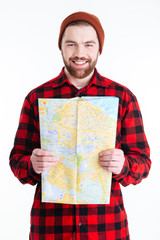 Smiling bearded handsome man holding a map over white background